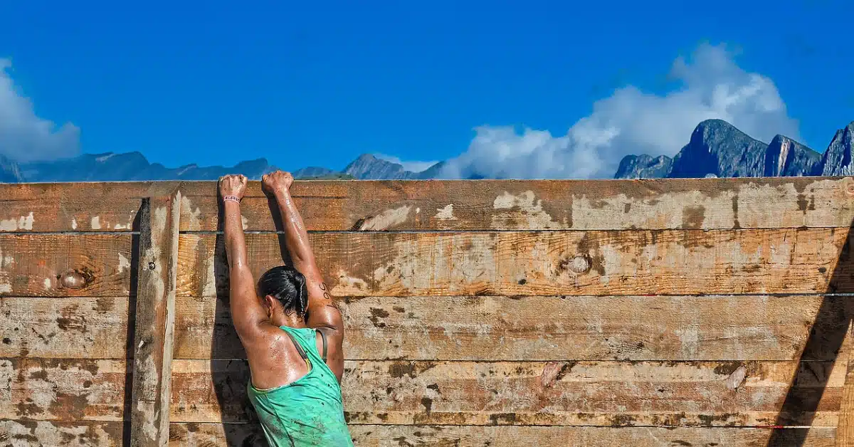 woman trying to climb a wall